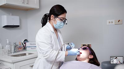 Dr. Shin providing emergency dental care for a patient at U Shine Dental in Alexandria, VA