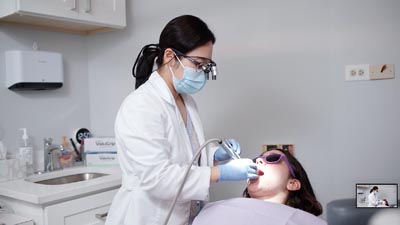 Dr. Shin providing cosmetic dental treatment to a patient at U Shine Dental in Alexandria, VA