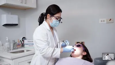 Dr. Shin providing cosmetic dental treatment to a patient at U Shine Dental in Alexandria, VA