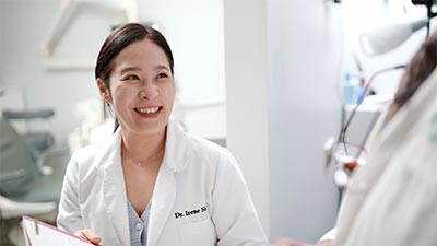 Dr. Shin speaking to a patient about teeth whitening